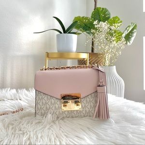 A small Michael Kors crossbody bag. Size 7.5*5.5 inches